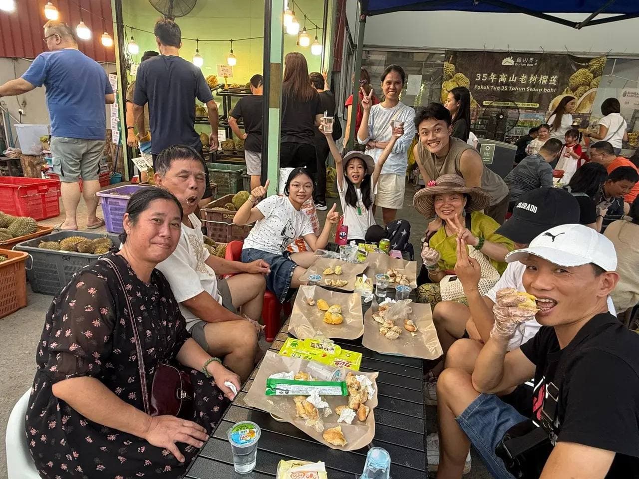 A group of friends and family sharing durian around a table at Durian Baa.
